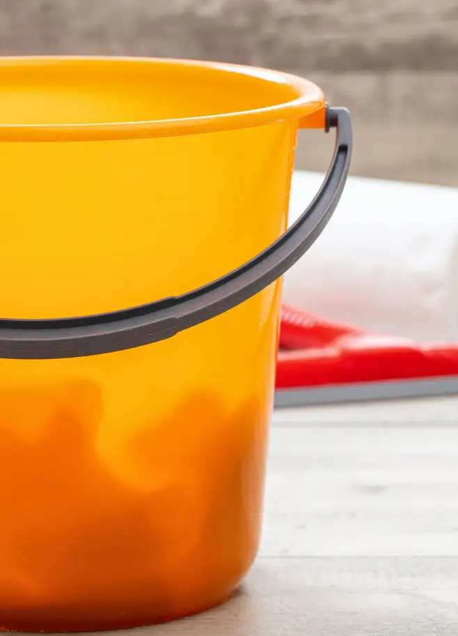 cleaning-bucket-orange-color-on-wooden-floor-backg